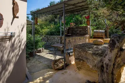 a bedroom with a bed under a pergola at The Olive House in Kondomari