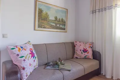 a living room with a couch with colorful pillows at Villa Galata in Galatás