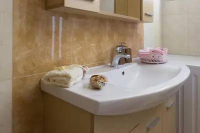 a bathroom with a sink with towels and a towel at Villa Galata in Galatás