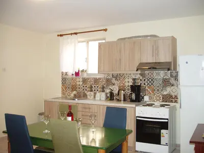 a kitchen with a table and a stove top oven at Chrynigema in Chania Town