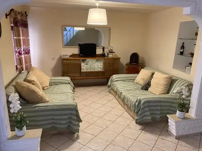 a living room with two couches and a tv at Chrynigema in Chania Town