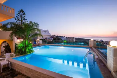 a large swimming pool on top of a building at Esplanade Apartments - Heated Pool in Kalathas