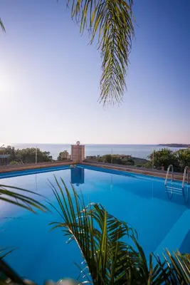 a swimming pool with a view of the ocean at Esplanade Apartments - Heated Pool in Kalathas