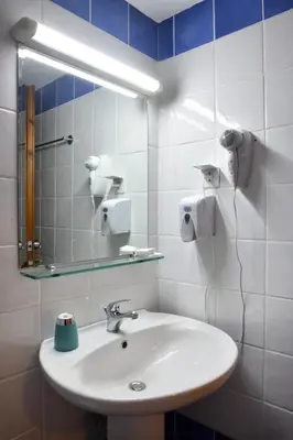 a bathroom with a sink and a mirror at Akatos Hotel in Agia Marina Nea Kydonias
