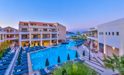 an overhead view of the resort pool at dusk at Porto Platanias Beach Resort & Spa in Plataniás