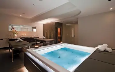a large bathroom with a large bath tub at Porto Platanias Beach Resort & Spa in Plataniás