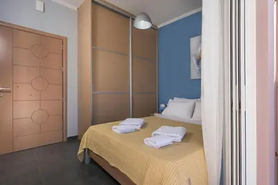 a bedroom with a bed with two towels on it at Astrantia in Chania Town