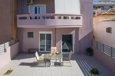 a balcony with a table and chairs on a building at Astrantia in Chania Town