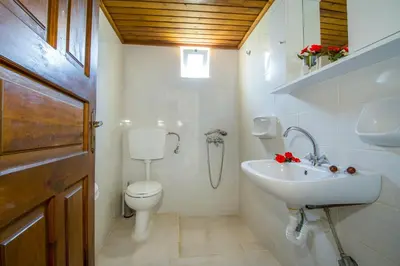 a white bathroom with a toilet and a sink at Studios Kydonia in Gerani Chanion
