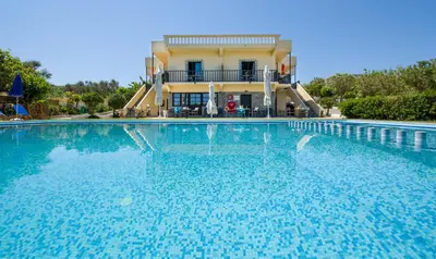 a large swimming pool in front of a house at Studios Kydonia in Gerani Chanion