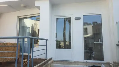 a door to a balcony with a view of the city at Elizabeth Suites in Kato Daratso