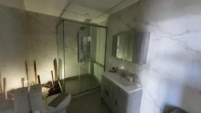 a bathroom with a shower and a toilet and a sink at Elizabeth Suites in Kato Daratso