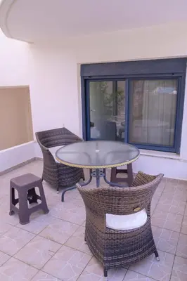 a patio with a table and wicker chairs at Elizabeth Suites in Kato Daratso
