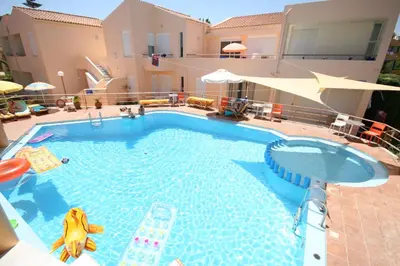a large swimming pool with a slide in a house at Elma's Dream Apartments & Villas in Kato Daratso