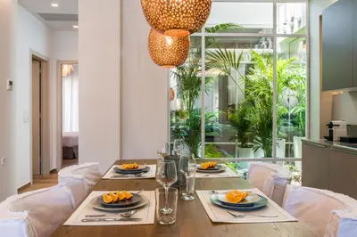 a dining room with a table and chairs and a large window at No17 Pireos Street in Chania Town