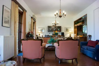 a living room with two chairs and a couch at Alexandra Villa Stalos in Stalos