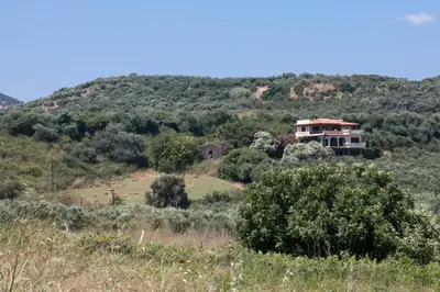 a house on a hill in the middle of a field at Alexandra Villa Stalos in Stalos