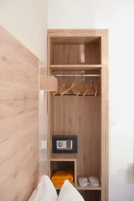 a room with a closet with a clock and shoes at Emmanouela's Apts in Kissamos