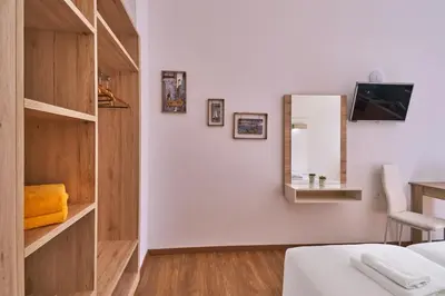 a bedroom with a bed and a mirror on a wall at Emmanouela's Apts in Kissamos