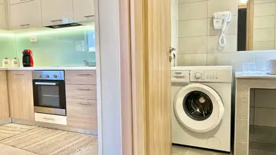 a kitchen with a washing machine in a kitchen at Emmanouela's Apts in Kissamos