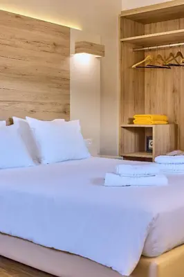 a large bed with white sheets and pillows at Emmanouela's Apts in Kissamos