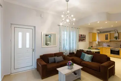 a living room with two brown couches and a table at Eleni Apartments in Chania Town