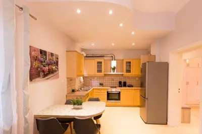 a kitchen with a table and a refrigerator at Eleni Apartments in Chania Town