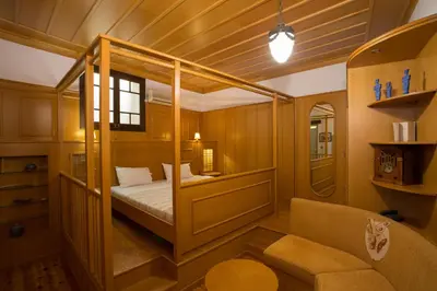 a small room with a bed and a chair at Nostos Hotel in Chania Town