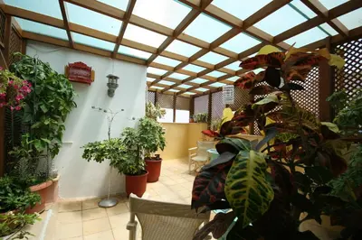 a room filled with lots of potted plants at Nostos Hotel in Chania Town