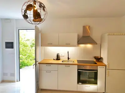 a kitchen with a sink and a refrigerator at MG Cozy Garden View Studio in Korakiaí
