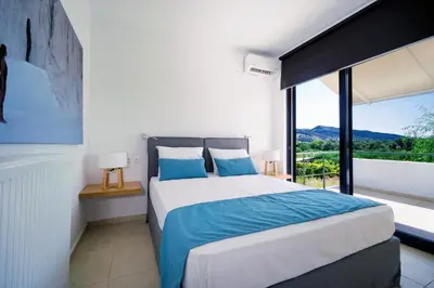 a bedroom with a bed and a large window at Seametry Villa in Chania Town