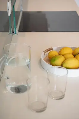 a counter top with glasses and a bowl of fruit at Seametry Villa in Chania Town