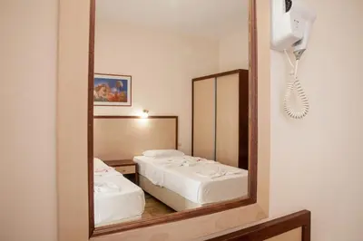 a mirror reflection of a bedroom with a bed at Ekavi Apartments in Agia Marina Nea Kydonias