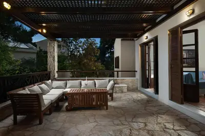 a patio with couches and a coffee table on a patio at Koukounari luxury villa in Chania Town
