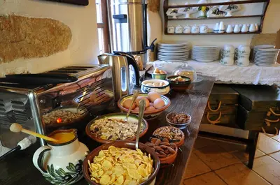 a buffet with many bowls of food on a table at Elia Hotel & Spa in Áno Voúvai