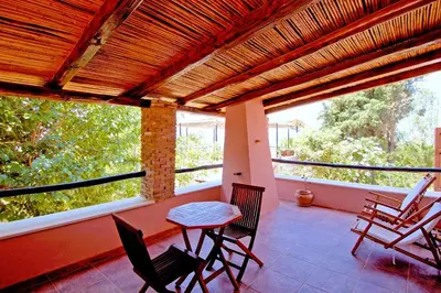 a room with a table and chairs on a balcony at Elia Hotel & Spa in Áno Voúvai
