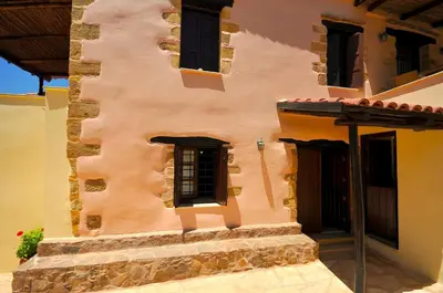 a large building with windows and a door at Elia Hotel & Spa in Áno Voúvai