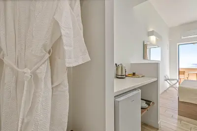a bathroom with a white towel hanging on a wall at Sofia's Lovely Rooms in Khóra Sfakíon