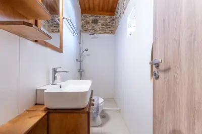 a bathroom with a sink and a toilet at Captain Nikolas in Keramotí