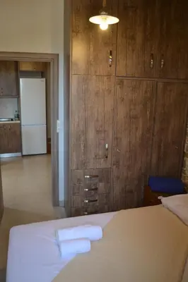 a bedroom with a bed with two towels on it at Captain Nikolas in Keramotí