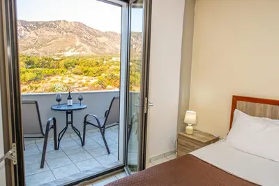 a bedroom with a bed and a table with chairs at Panorama in Elafonisi