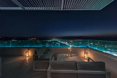 a living room with a view of a city at night at Aenaon Seaview Villa in Plataniás