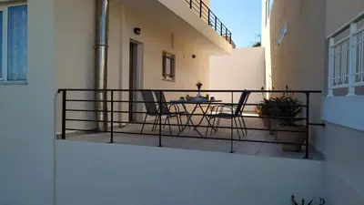 a balcony with a table and chairs on it at Apartment next to the beach in Kato Daratso