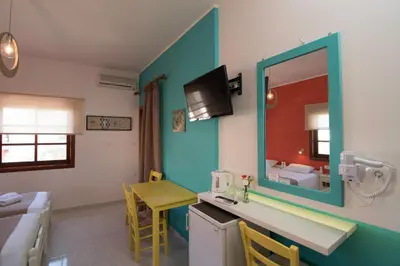 a bathroom with a sink and a mirror at Niki Rooms in Palaiochóra