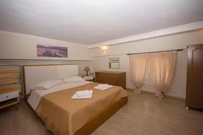 a bedroom with a bed with two towels on it at Maria's house in Kissamos