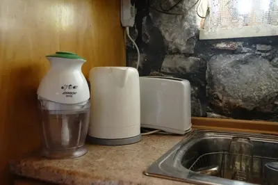 a kitchen counter with a blender next to a sink at Mike Omalos Houses in Omalós
