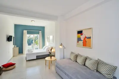 a living room with a couch and a bed at Casa Manolesos in Chorafakia