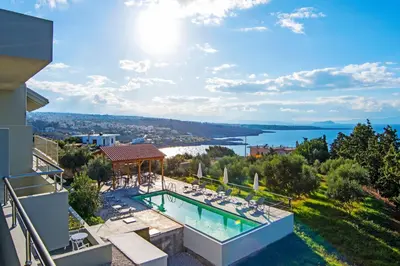 a villa with a swimming pool and a view of the water at Casa Manolesos in Chorafakia