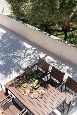 a picnic table with plates of food and fruit on it at Margiani House in Kaláthenai