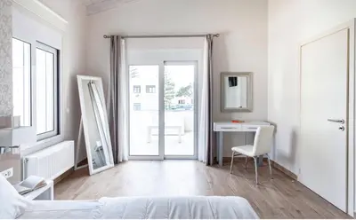 a bedroom with a bed and a desk and a mirror at Villa Despina in Kisamos in Kissamos